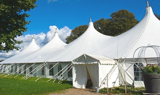 a row of portable restrooms placed outdoors for attendees of a event in Home, PA